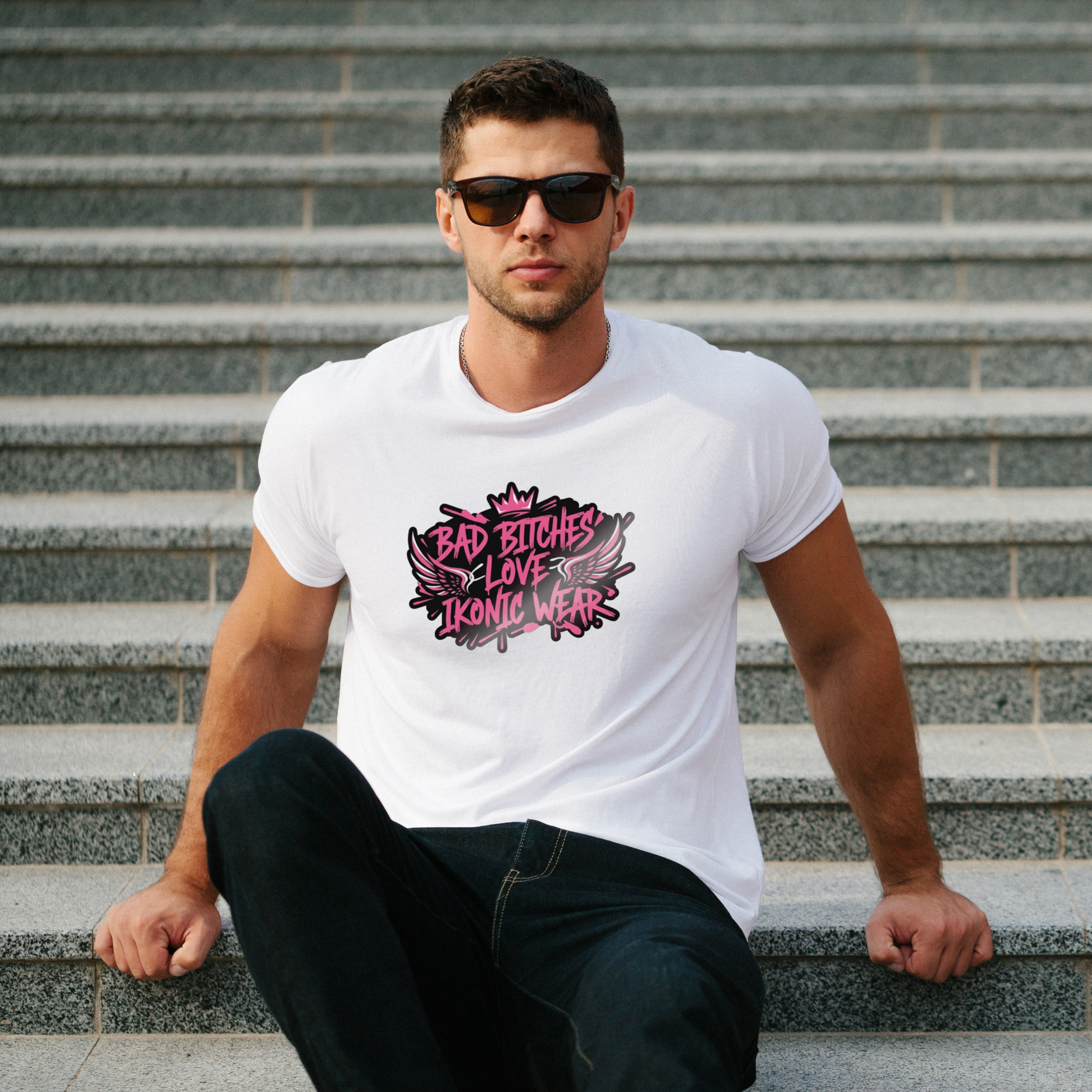 Man wearing a white t-shirt with graphic text sitting on steps