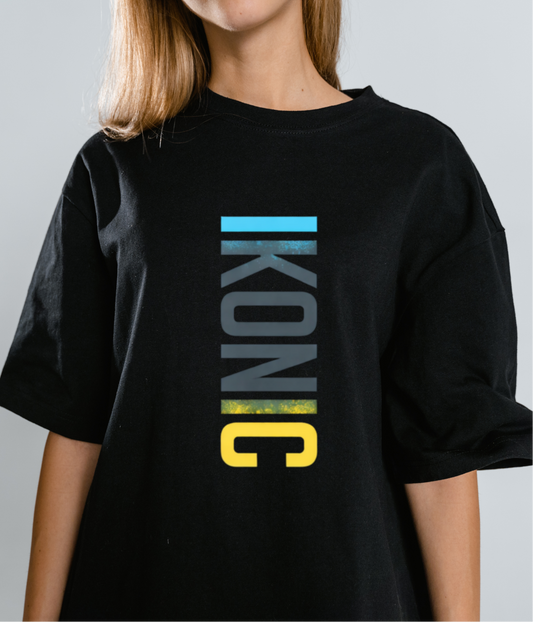 Person wearing a black t-shirt with 'IKONIC' logo on a plain background