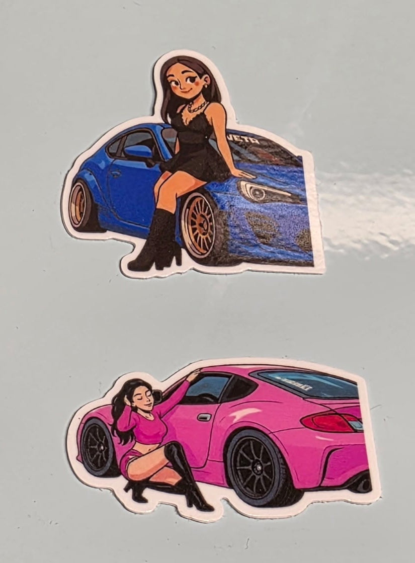 Close-up image of stickers featuring a woman with a blue car and a woman with a pink car on a gray background.